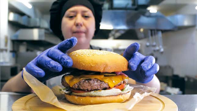 Chef preparing burger in restaurant kitchen back of house