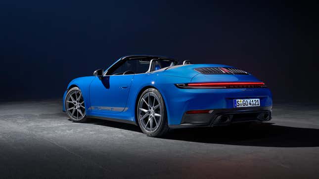 Rear 3/4 view of a blue 2025 Porsche 911 Carrera T cabriolet