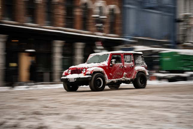 NASHVILLE, TENNESSEE - JANUARY 15: Image of a car driving on Lower Broadway covered in snow after a snow storm on January 15, 2024 in Nashville, Tennessee.