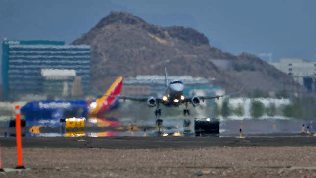 A jet takes flight as heat ripples radiate from the runway, Tuesday, July 25, 2023 at Sky Harbor International Airport, in Phoenix.