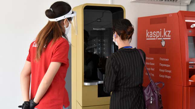 A woman uses a machine patented by the Kazakh company Kaspi.kz in Almaty, Kazakhstan July 29, 2020. The cartomat (cardomat) instantly manufactures and delivers banking cards to clients.