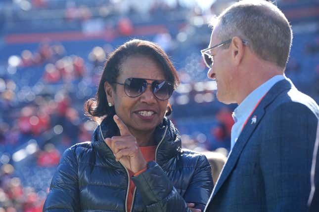 Denver Broncos owner Condoleezza Rice, left, talks with owner and chief executive officer Greg Penner before an NFL football game against the Las Vegas Raiders in Denver, Sunday, Nov. 20, 2022.