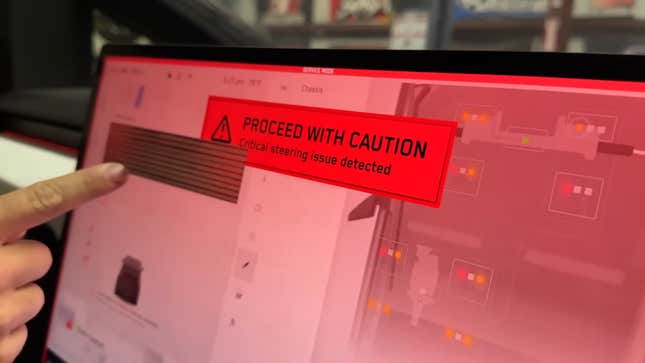 A photo of a Cybertruck screen with a "proceed with caution" message. 