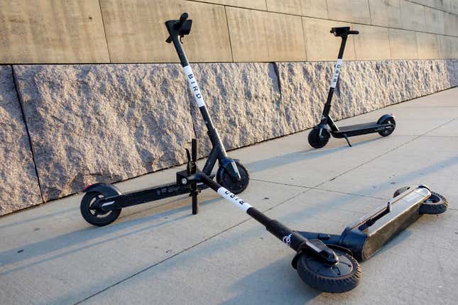 FILE - Sharable electric scooters by Bird Rides, Inc. wait on downtown sidewalks for pedestrian use, Oct. 2, 2019, in downtown Cincinnati. Electric scooter company Bird Global announced Wednesday, Dec. 20, 2023, that it has filed for bankruptcy protection in an attempt to stabilize its wobbly finances. (AP Photo/John Minchillo, File)