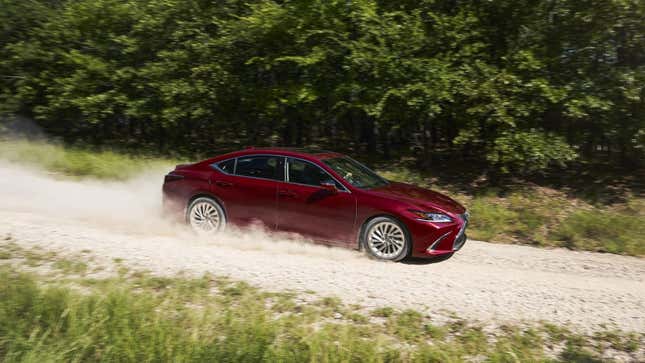 A red lexus ES350 driving on a dirt road