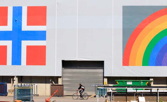 A man cycles past a warehouse in Oslo, Norway.