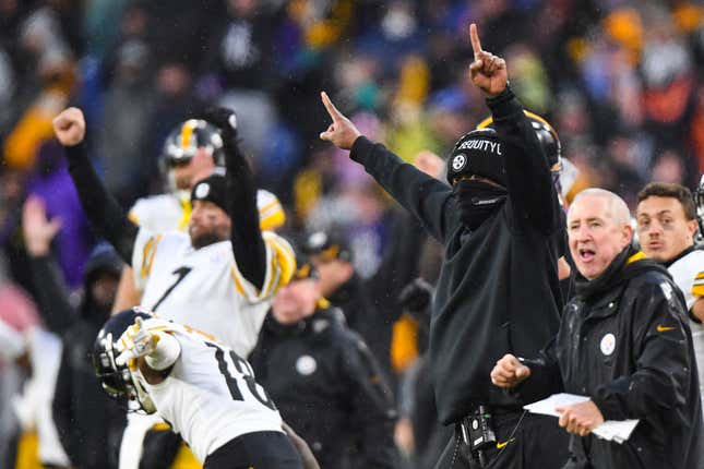 Pittsburgh Steelers head coach Mike Tomlin, masked, reacts to overtime game-winning kick by kicker Chris Boswell after an NFL football game against the Baltimore Ravens, Sunday, Jan. 9, 2022, in Baltimore. 