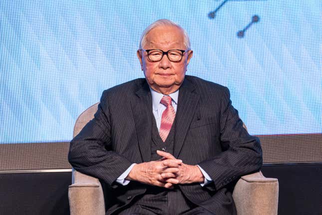 Morris Chang sitting in a chair with his hands clasped together