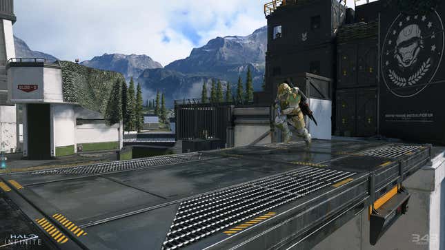 An action shot of Halo Infinite depicting a spartan charging across a metal walkway, gun in hand.