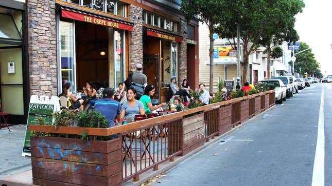 People eat outside in a parklet