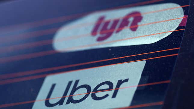 Uber and Lyft signs are seen on a car in Redondo Beach, California, U.S., March 25, 2019. REUTERS/Lucy Nicholson – RC1F359D1320