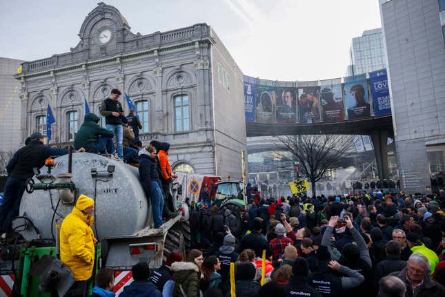 Farmers on tractors create chaos outside an EU summit to protest rising  costs and bureaucracy