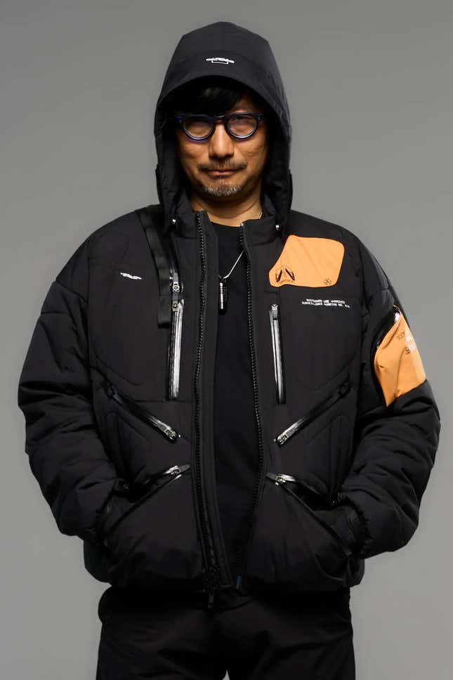 1) Sleek limited edition Death Stranding 2 jacket displayed on a bust2) Close-up of the high-quality stitches and fabric of the Death Stranding 2 jacket3) Detailed view of the unique Death Stranding 2 logo on the jacket 4) Lifestyle shot of a model posing in the stylish Death Stranding 2 jacket 5) New Death Stranding 2 jacket paired with matching game accessories.6) Hero shot of the Death Stranding 2 jacket, highlighting its exclusive design.