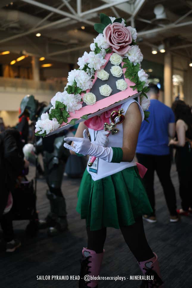 A cosplayer that combined Sailor Moon and Pyramid Head strides through the convention. 