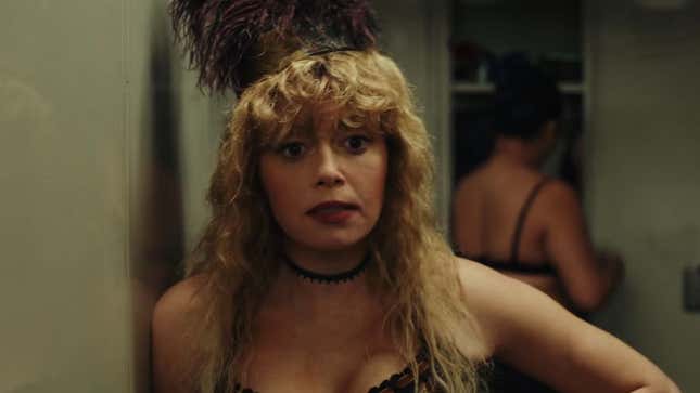 Charlie in her casino outfood, looking bemused.