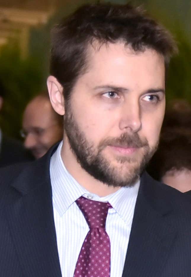 White House advisor Brian Deese walks to attend a meeting at the COP 21 UN Conference in a dark blue and tie in this 2015 file photo.