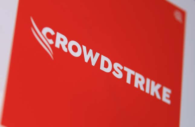 orange logo of the IT security company Crowdstrike photographed from the screen of a laptop