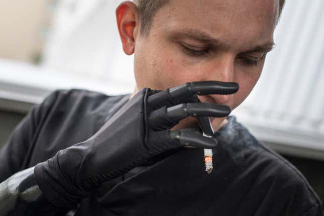 Dr. Alexis Cholas smokes a cigarette using his bionic hand outside of the hospital&#39;s rehabilitation center in Kyiv, Ukraine, Wednesday, Nov. 8, 2023. &quot;I feel uncomfortable when I&#39;m without the prosthesis,&quot; he says. &quot;But when I have the bionic arm on, I feel comfortable. It&#39;s like a part of you.&quot; (AP Photo/Evgeniy Maloletka)