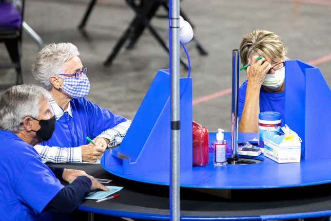 Contractors working for Cyber Ninjas, who the Arizona State Senate hired, examine and recount ballots from the 2020 general election at Veterans Memorial Coliseum on May 1, 2021, in Phoenix, Arizona.