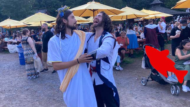 A guy dressed as assassin's creed assassin pretends to assassinate a guy dressed as Jesus at a Renaissance Faire.