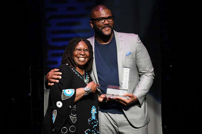 Whoopi Goldberg presents Tyler Perry the Impact Award at the Apollo Theater Spring Benefit.