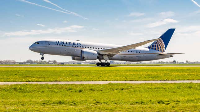 United Airlines Boeing 787-8 Dreamliner aircraft as seen during take off passing in front of the control tower and flying as it is departing from Amsterdam Schiphol Airport AMS EHAM in a blue sky day.