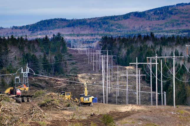 FILE - Heavy machinery is used to cut trees to widen an existing Central Maine Power power line corridor to make way for new utility poles, April 26, 2021, near Bingham, Maine. Stalled spending on electrical grids worldwide is slowing the rollout of renewable energy and could put efforts to limit climate change at risk if millions of miles of power lines aren&#39;t added or refurbished in the next few years. The International Energy Agency said in a report Tuesday that the capacity to connect to and transmit electricity isn&#39;t keeping pace with the rapid growth of clean energy technology like solar and wind power, electric cars and heat pumps. (AP Photo/Robert F. Bukaty, File)