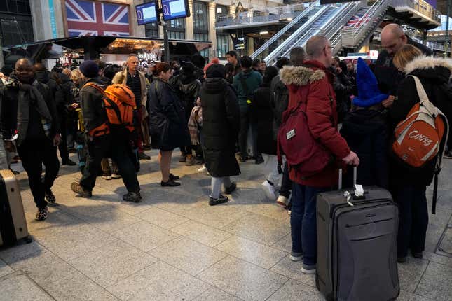 Stranded passengers wait at the Gare du Nord station, Thursday, Dec. 21, 2023 in Paris. The last-minute strike by Eurotunnel operator Getlink began around noon, forcing the train operator to cancel all trains to and from London. Trains between London, Amsterdam and Brussels were also affected. (AP Photo/Michel Euler)