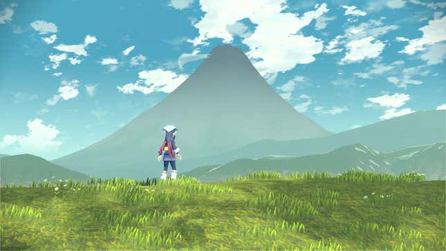 The hero of Pokémon Legends: Arceus gazes out over a vast green field, a mountain rising in the distance. 