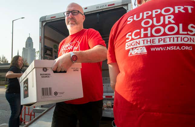 FILE - Paul Schulte, a sponsor of the Support Our Schools Nebraska petition drive, delivers a box of signatures to the Nebraska Secretary of State, Aug. 30, 2023, in Lincoln, Neb. Nebraska’s top election official confirmed Tuesday, Oct. 10, that state voters will decide next year whether public money can go to private school tuition. (Justin Wan/Lincoln Journal Star via AP, File)