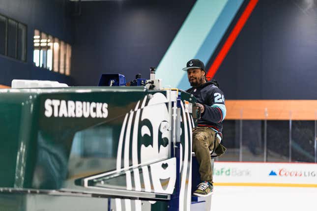 Marshawn Lynch drives a Zamboni ice clearing machine on the home ice for the NHL’s Seattle Kraken, which he now owns a piece of. 