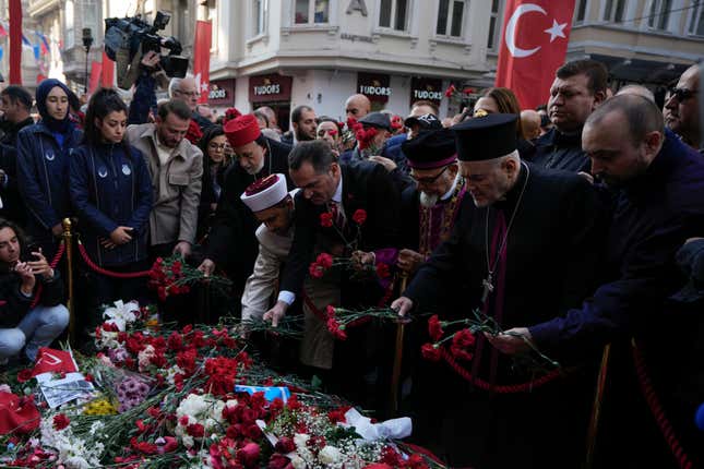 FILE - Representatives of the Turkish communities put flowers over a memorial placed on the spot of Sunday&#39;s explosion on Istanbul&#39;s popular pedestrian Istiklal Avenue in Istanbul, Turkey, Wednesday, Nov. 16, 2022. Alham Albashir, alleged bomber of a deadly blast killing six and injuring 99, received 7 consecutive life sentences by an Istanbul court on Friday, April 26, 2024, Turkey’s state-run news agency reported. (AP Photo/Khalil Hamra, File)