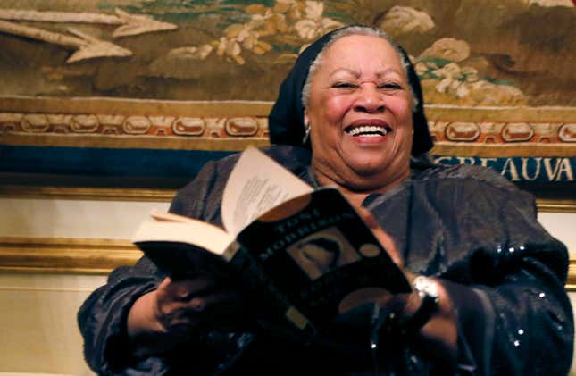 Toni Morrison poses with her 1977 novel entitled “Song of Solomon” on September 21, 2012 during a reception sponsored by the US ambassador Charles H. Rivkin (R) at his residence in Paris, as part of the 10th America Festival.