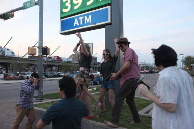 Members of the 21st Co-op dance on the corner of 6th street and I-35 on March 13, 2012 during the South by SouthWest music festival in Austin, Texas. 