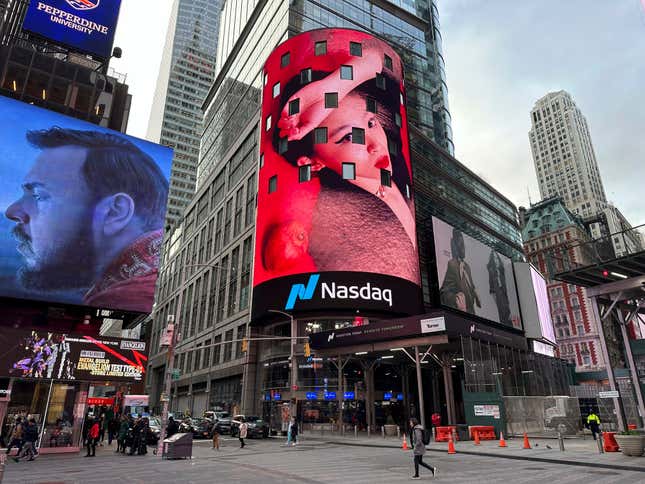 Pedestrians walk past the Nasdaq building in New York on Tuesday, March 26, 2024. Donald Trump’s social media company begins trading publicly Tuesday. Trump Media &amp; Technology Group Corp. was acquired Monday by a blank-check company called Digital World Acquisition Corp. Trump Media, which runs the social media platform Truth Social, now takes Digital World’s place on the Nasdaq stock exchange. (AP Photo/Peter Morgan)