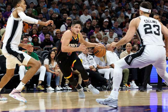 Oct 31, 2023; Phoenix, Arizona, USA; Phoenix Suns guard Grayson Allen #8 drives to the net agaisnt San Antonio Spurs center Victor Wembanyama #1 and forward Jeremy Sochan #10 during the second quarter at Footprint Center.