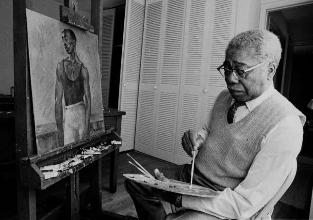 Portrait of African American painter Aaron Douglas (1899 - 1979), long time professor at Fisk University, and a leading figure in the Harlem Renaissance, painting at his easel, Tennessee, ca.1970s.