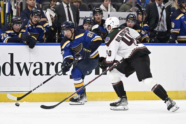 Sep 23, 2023; St. Louis, Missouri, USA; St. Louis Blues center Jordan Kyrou (25) controls the puck from Arizona Coyotes defenseman Peter Diliberatore (40) during the second period at Enterprise Center.