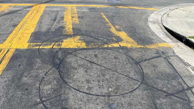 A photo of a circular induction loop right before a crosswalk on a road in Los Angeles, CA