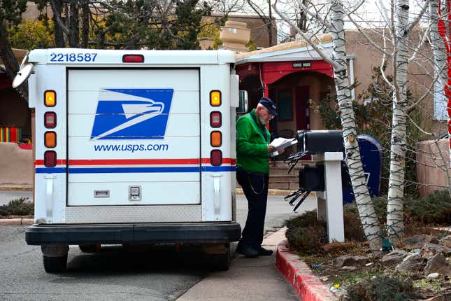 A United States Postal Service postman delivers mail along Canyon Road in Santa Fe, New Mexico.