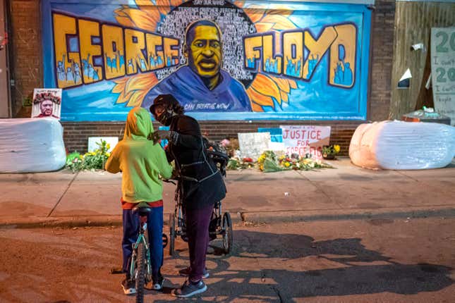 Shannon Haynes talks to her son Ronald Haynes, 9, about George Floyd in front of a memorial following the verdict in the Derek Chauvin trial on April 20, 2021 in Minneapolis, Minnesota. The former Minneapolis police officer was found guilty today on all three charges he faced in the death of Floyd last May.