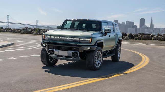 A photo of a green electric Hummer on an empty street