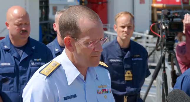 Rear Admiral stands in front of coast guard members to announce the lost of the private submersible Titan.  