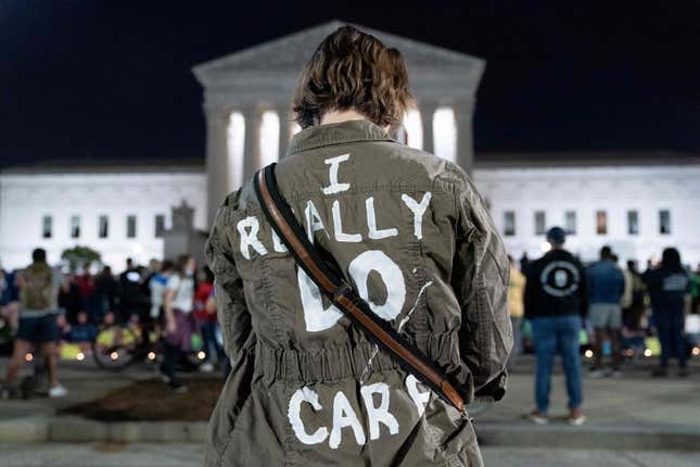 A woman wears a jacket reading I really do care at the US Supreme Court in Washington, DC, on May 2, 2022. 