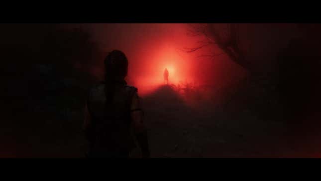 A dark silhouette pierces a glowing red light before Senua.
