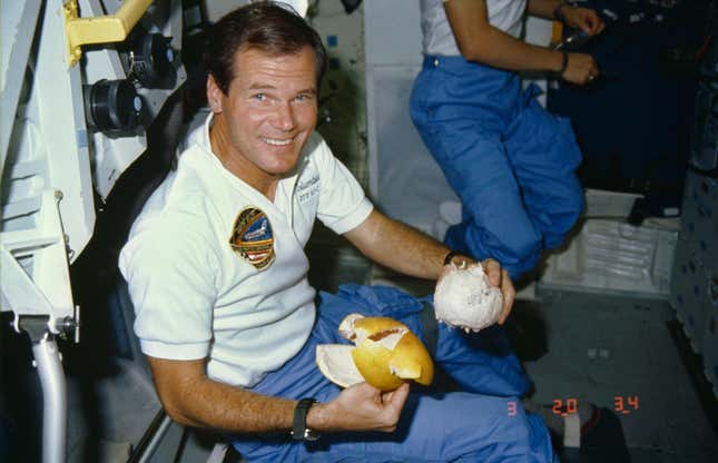 Rep. Bill Nelson prepares to enjoy a freshly peeled grapefruit on the middeck of the earth-orbiting Space Shuttle Columbia.