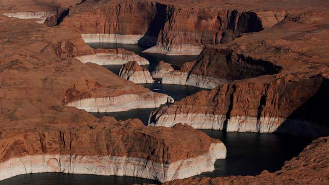 The tall bleached “bathtub ring” is visible on the rocky banks of Lake Powell on June 24, 2021 in Page, Arizona