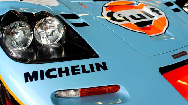 A photo of the headlamp and hood of a McLaren F1 painted in orange and blue for Gulf. 