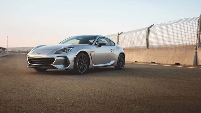 A silver Subaru BRZ on a race track