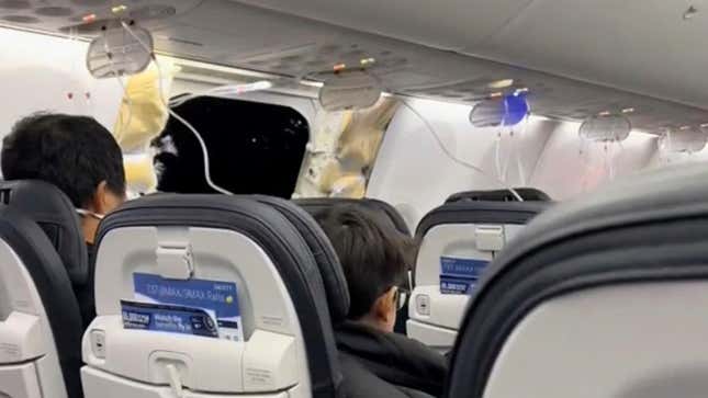 This image from video provided by Elizabeth Le shows passengers near the damage on an Alaska Airlines Boeing 737 Max 9, Flight 1282, which was forced to return to Portland International Airport on Friday, Jan. 5, 2024.